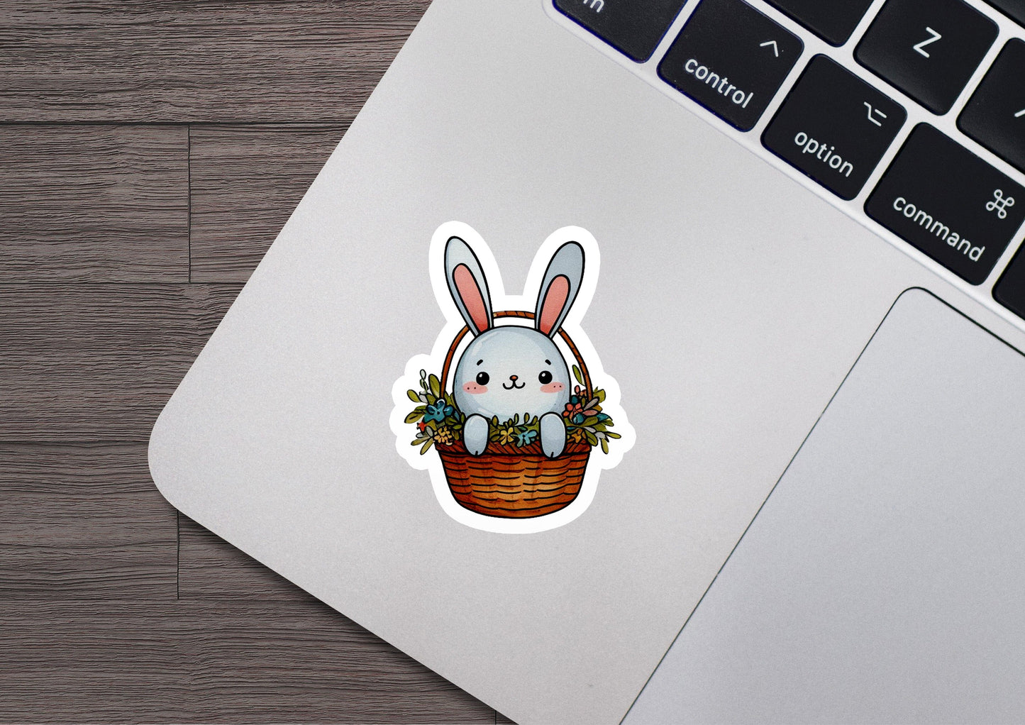 a laptop with a sticker of a bunny in a basket
