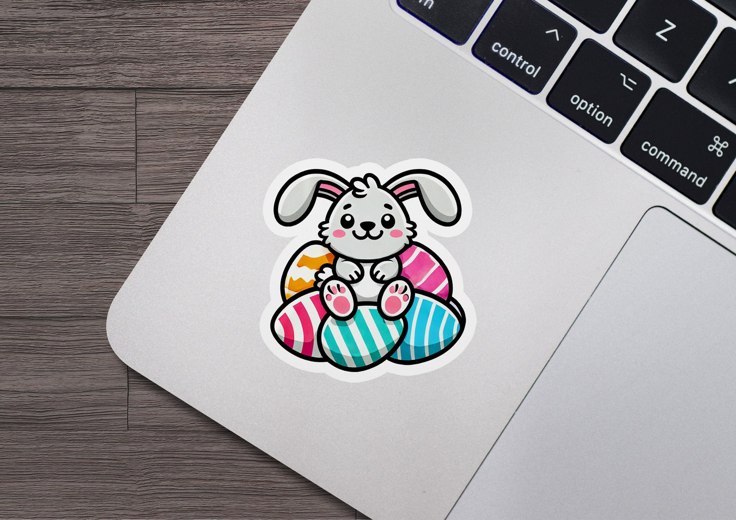 a laptop with a sticker of a bunny in an egg