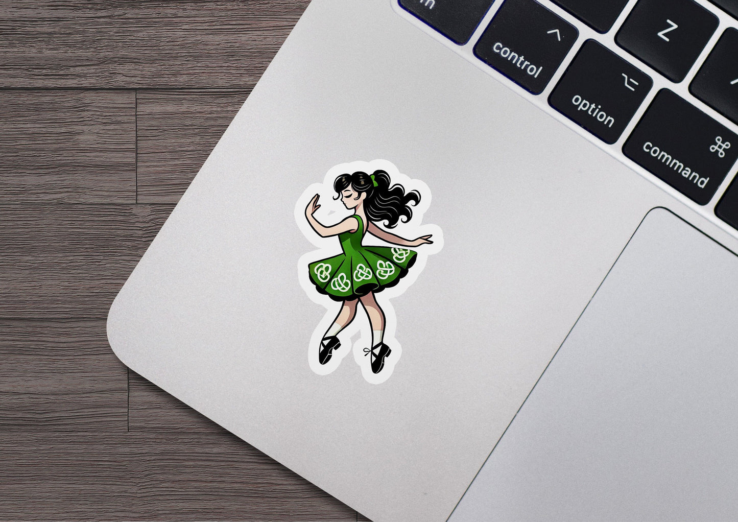 a laptop with a sticker of a woman dancing