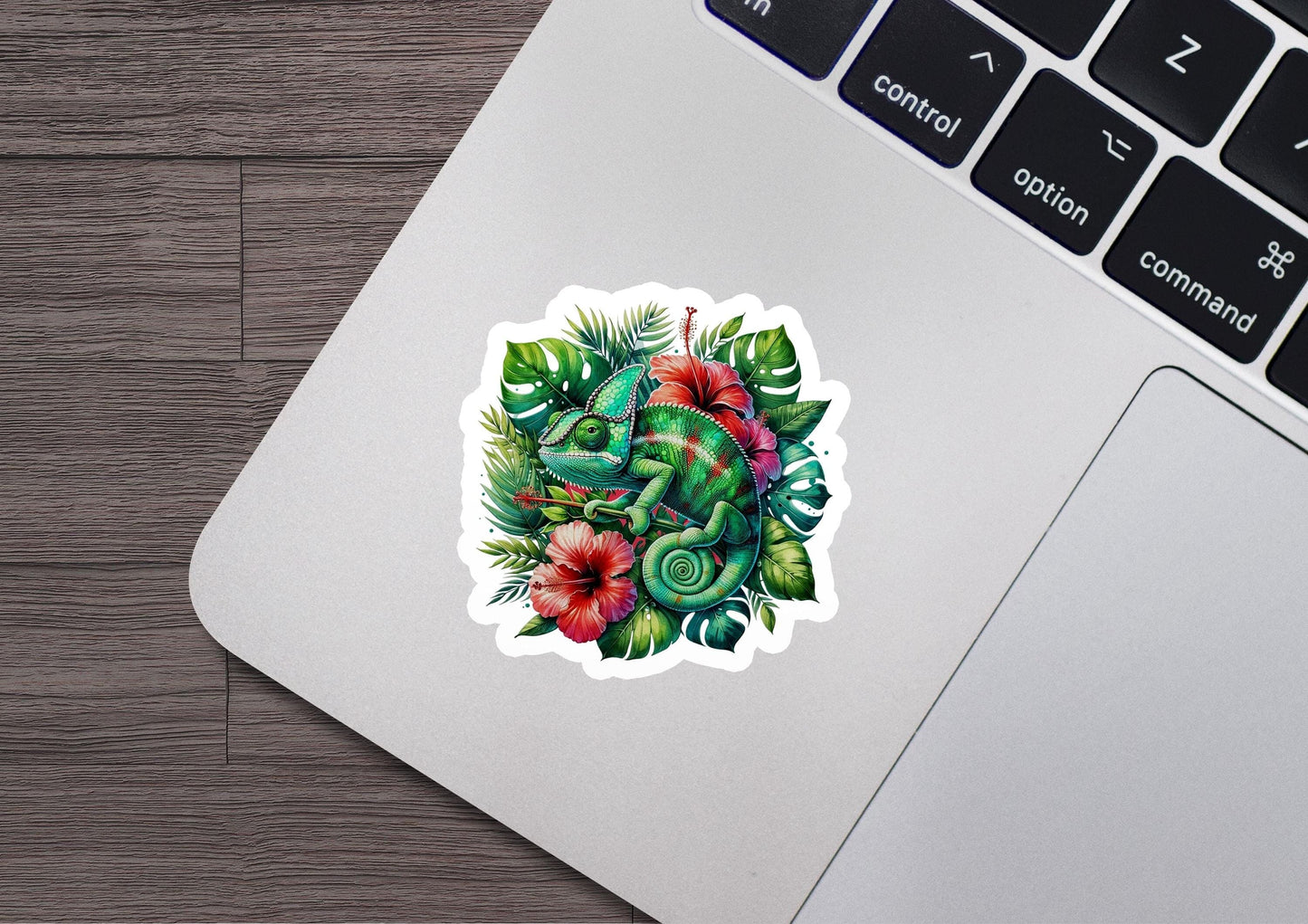 a laptop with a sticker of an elephant surrounded by flowers