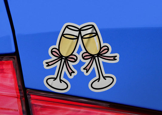 a pair of champagne flutes sticker on the back of a car