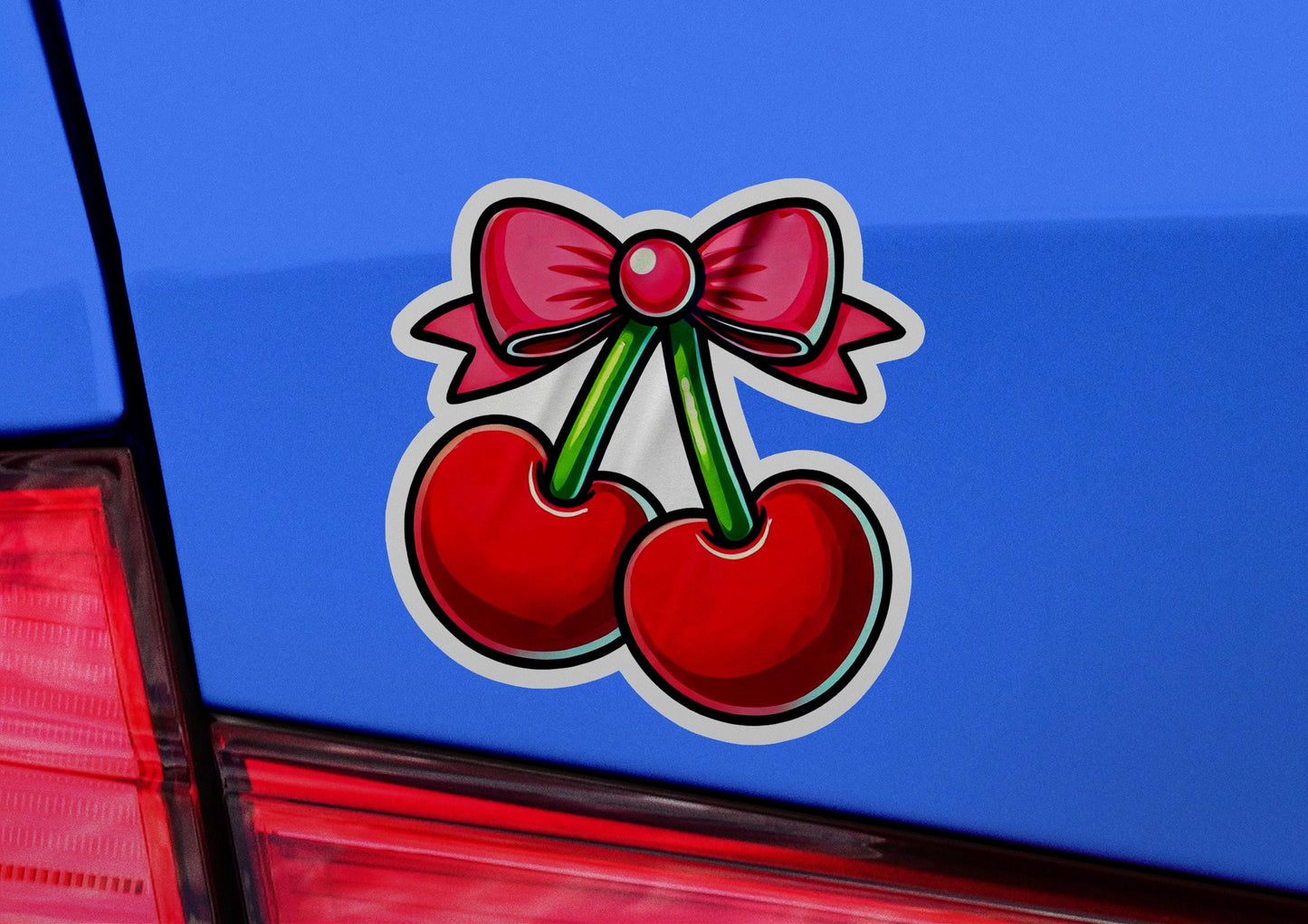 a sticker of two cherries with a bow