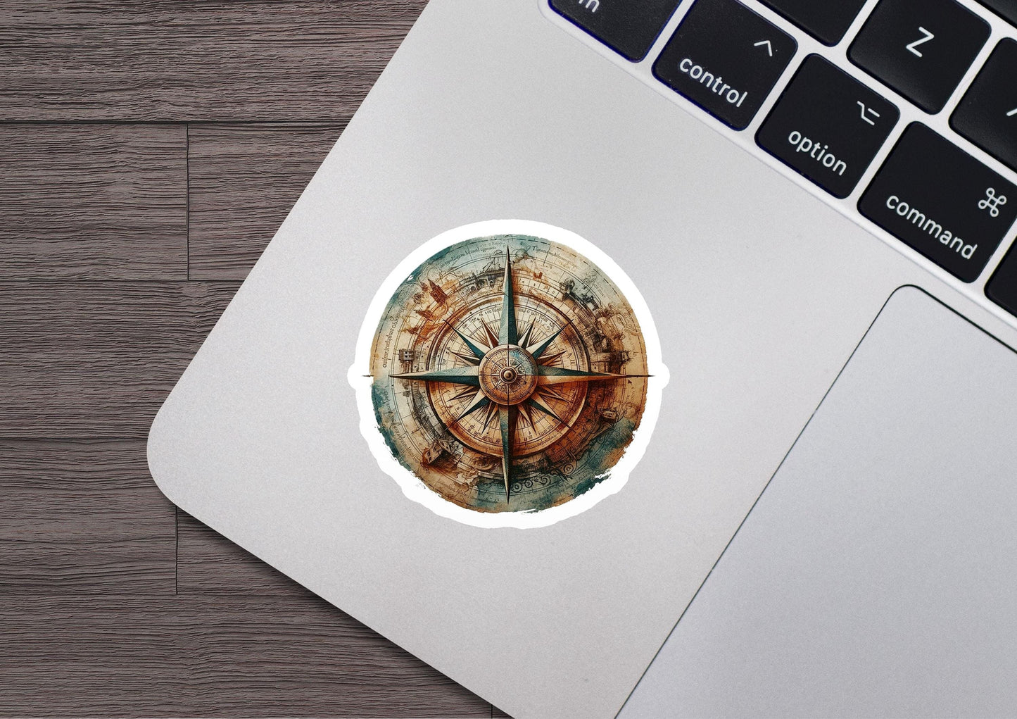 a sticker of a compass on a laptop