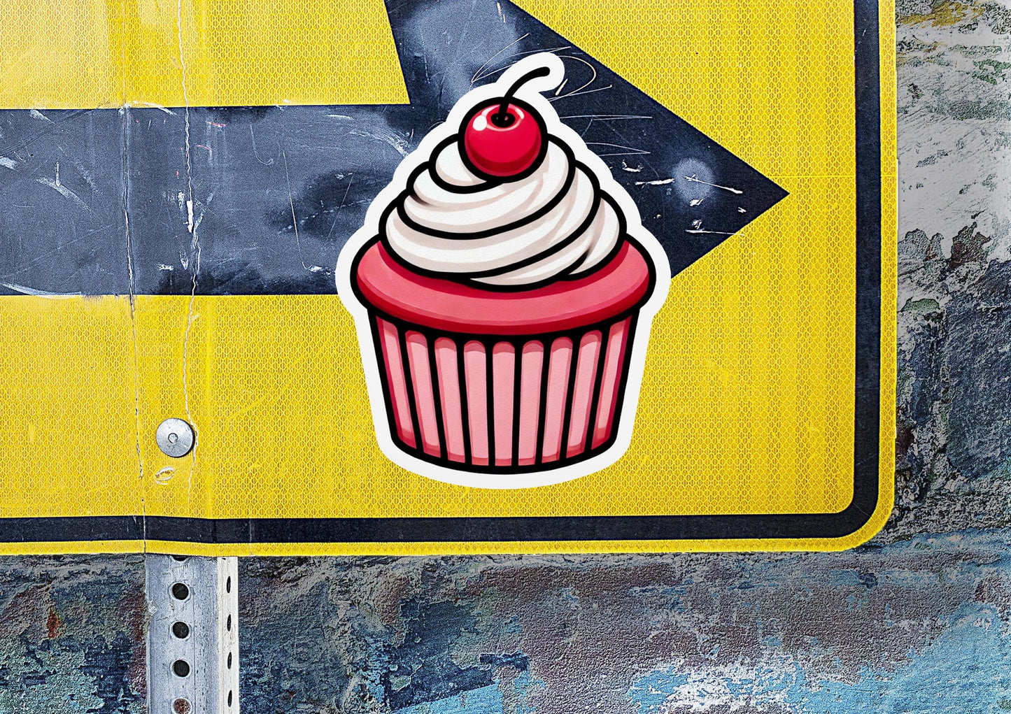 a street sign with a cupcake sticker on it