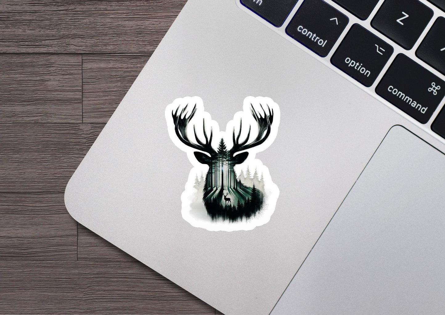 a laptop with a sticker of a deer's head