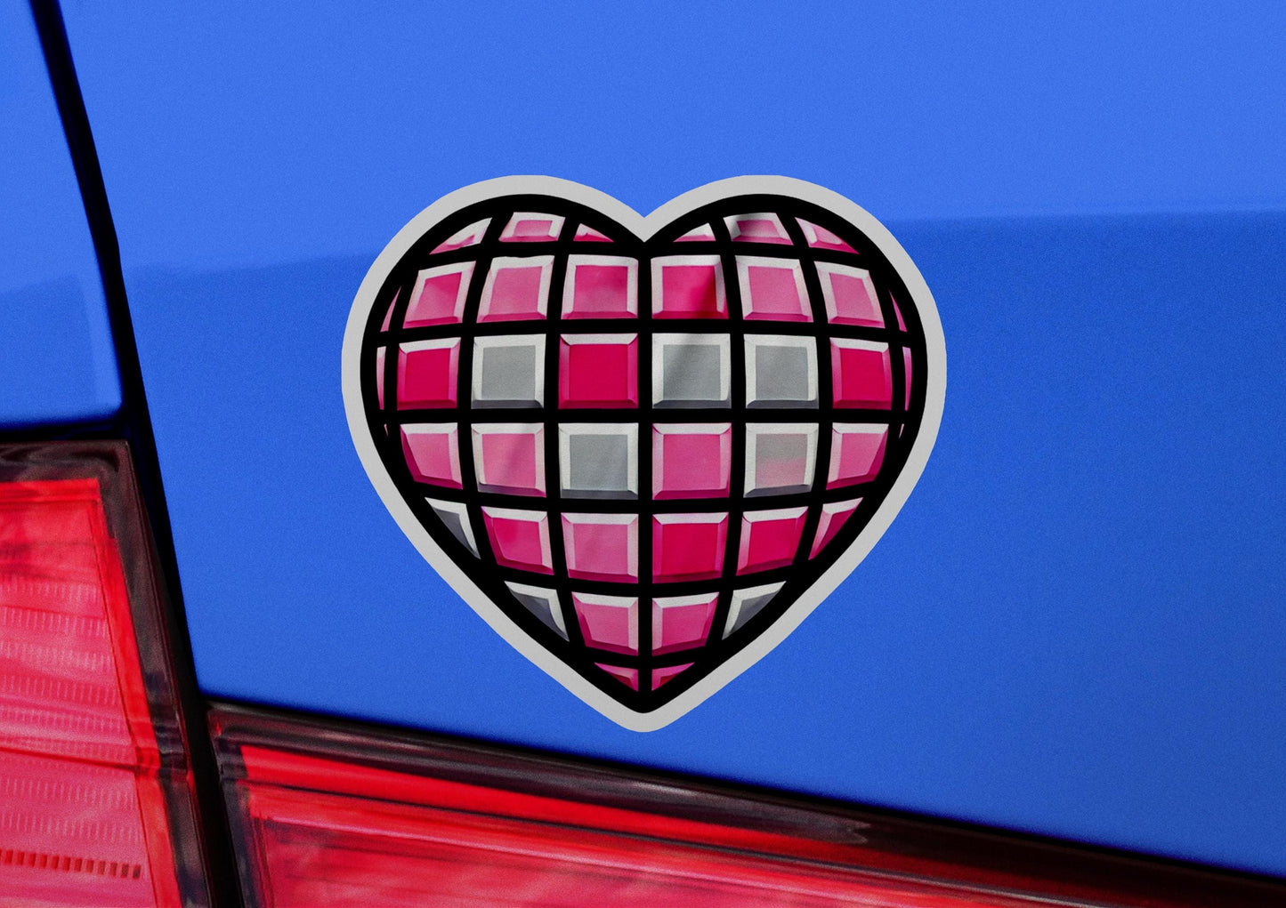 a heart shaped sticker on the back of a car