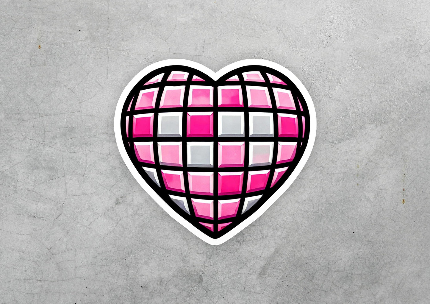 a heart shaped sticker on a concrete surface