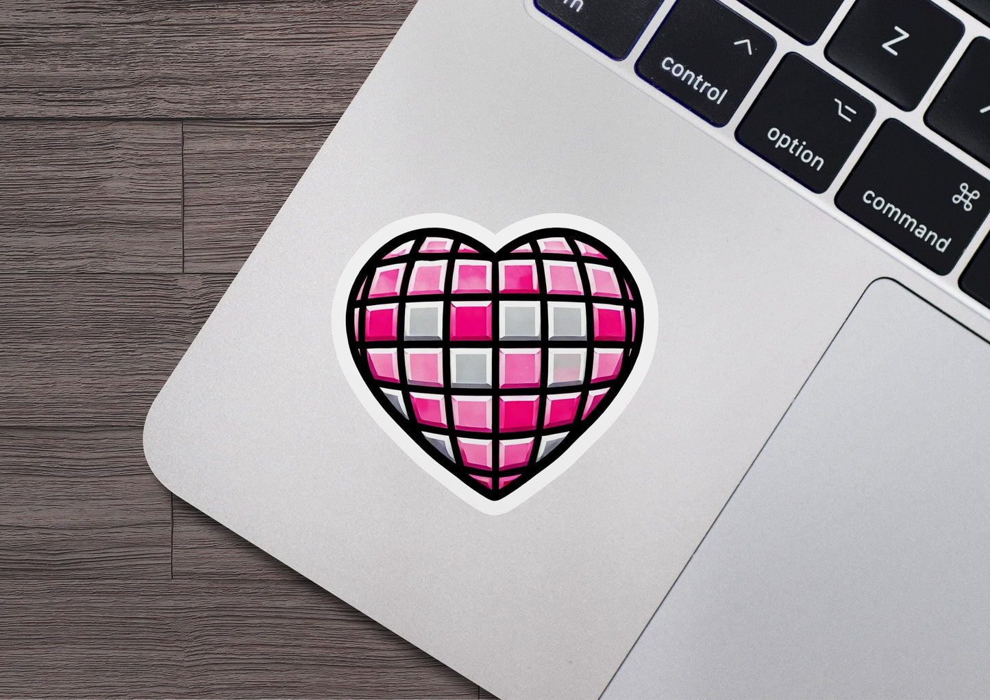 a heart sticker on a laptop keyboard