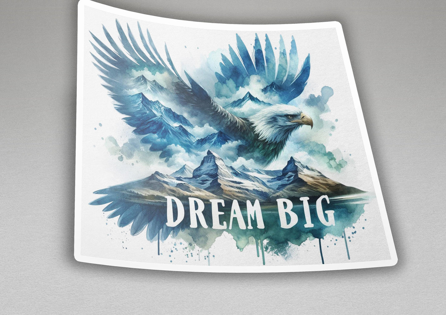 a sticker with an eagle flying over a mountain range