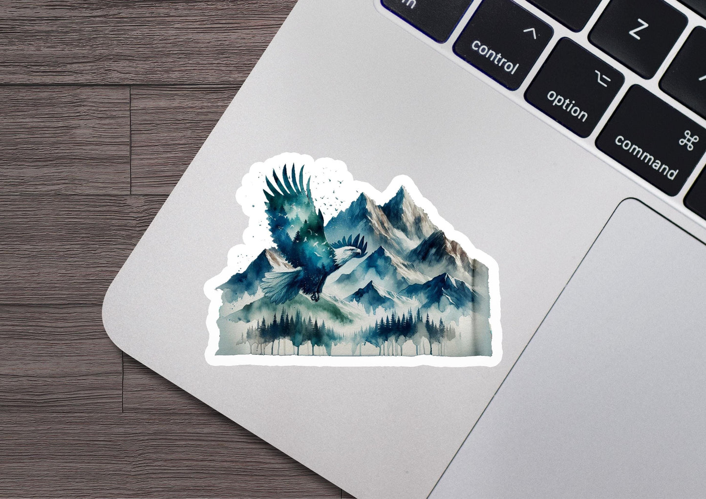 a sticker of a bird flying over a mountain range