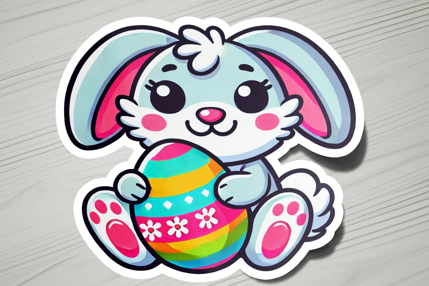 a sticker of a bunny holding an easter egg