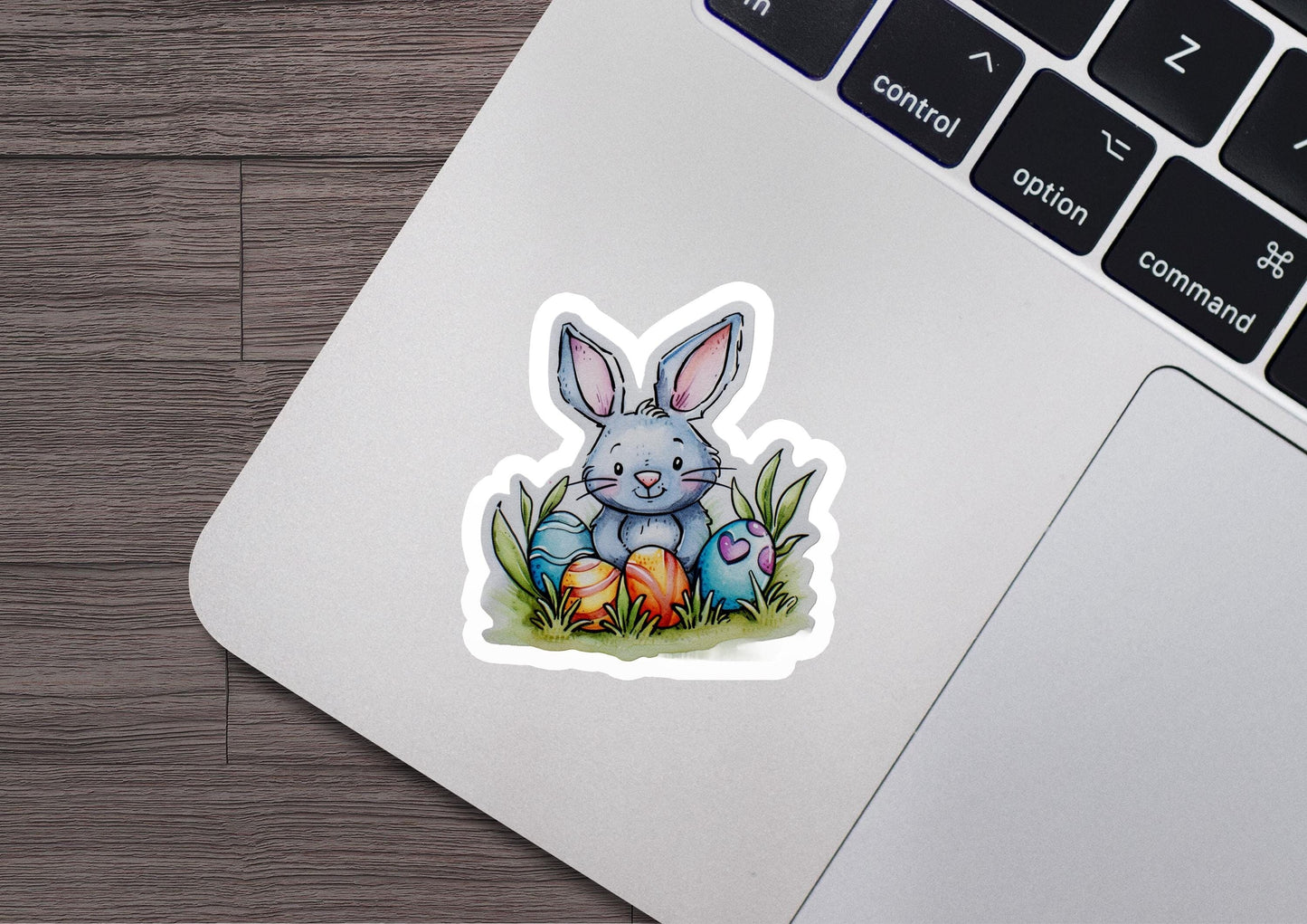 a laptop with a sticker of a bunny sitting on top of it