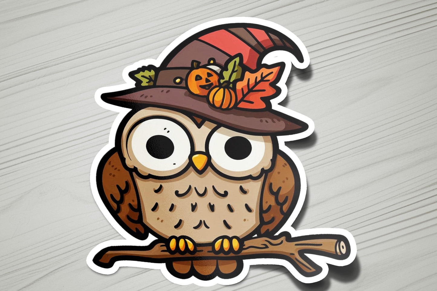 a sticker of an owl wearing a witches hat