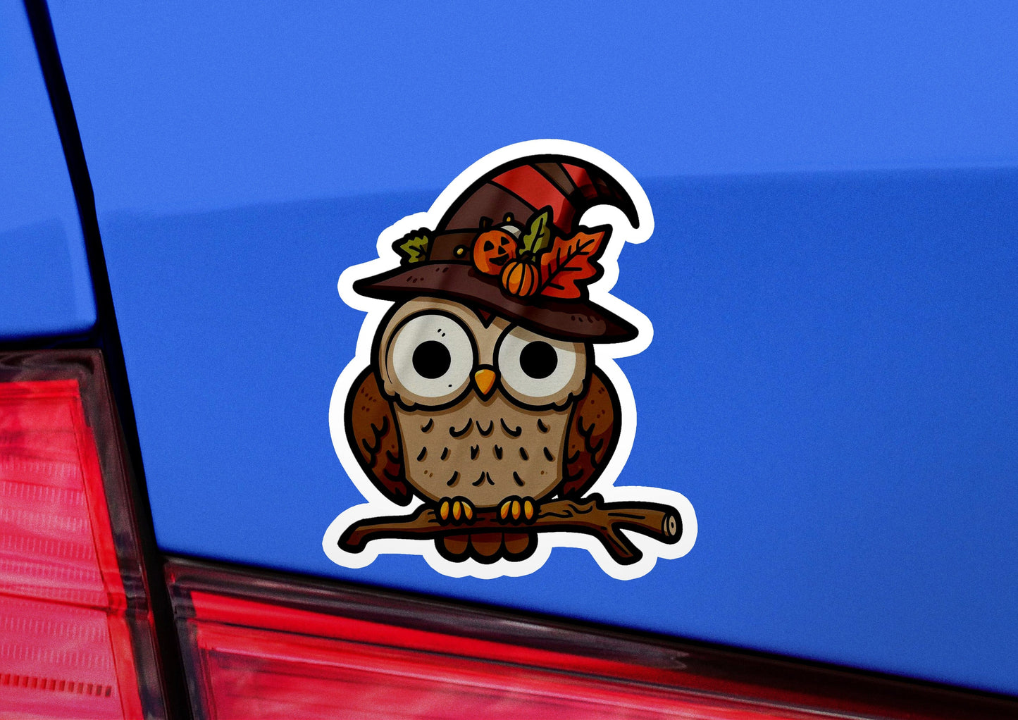 a sticker of an owl wearing a hat and holding a branch