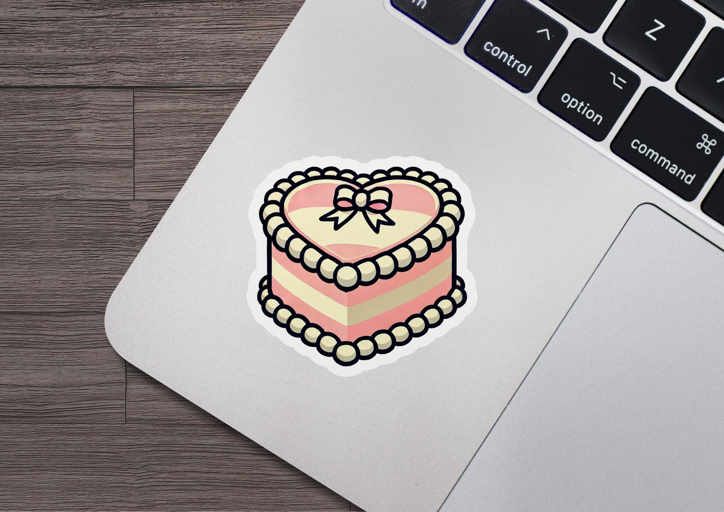a heart shaped cake sticker on a laptop