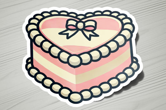 a heart shaped cake with a bow on top of it