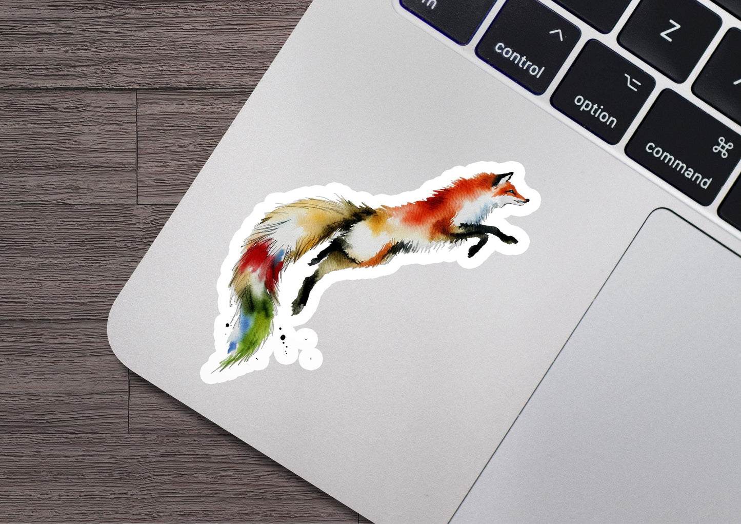 a sticker of a fox on a laptop