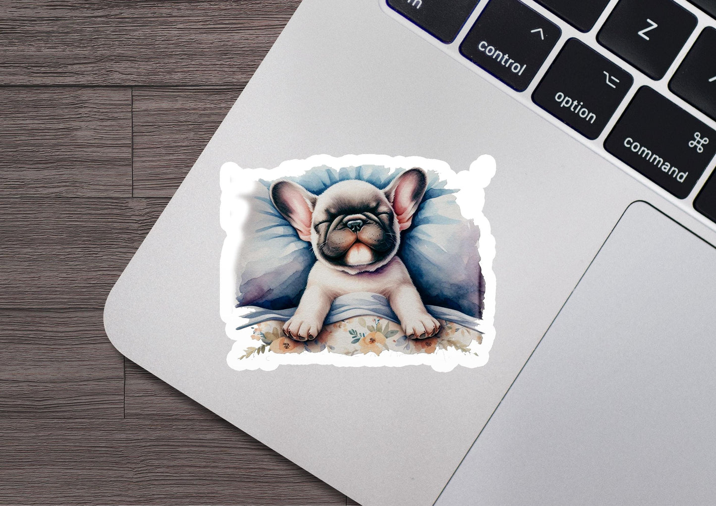 a sticker of a french bulldog on a laptop