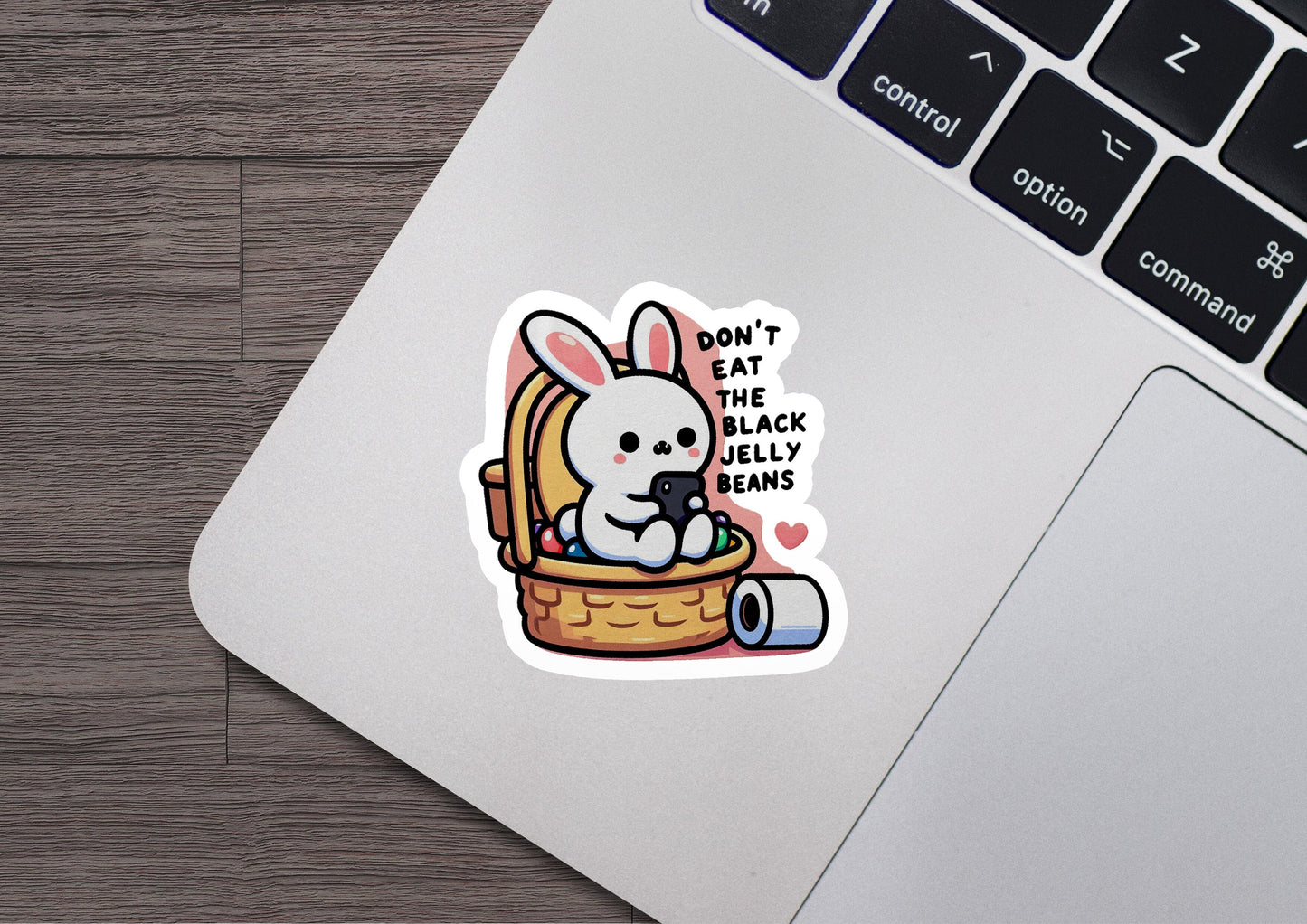a laptop with a sticker of a bunny in a basket
