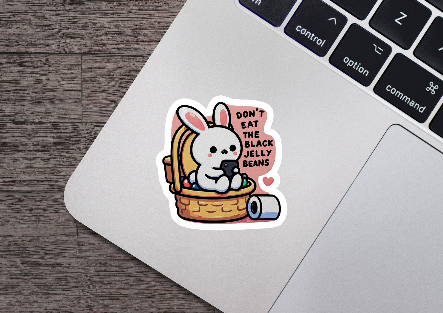 a laptop with a sticker of a bunny in a basket
