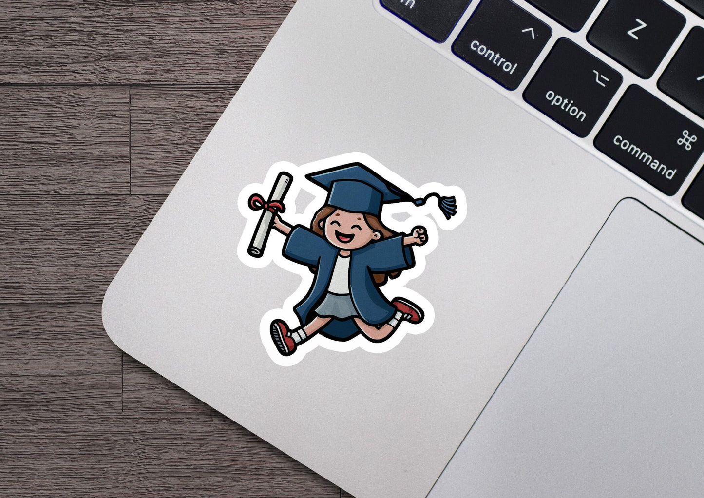 a laptop with a sticker of a graduate running