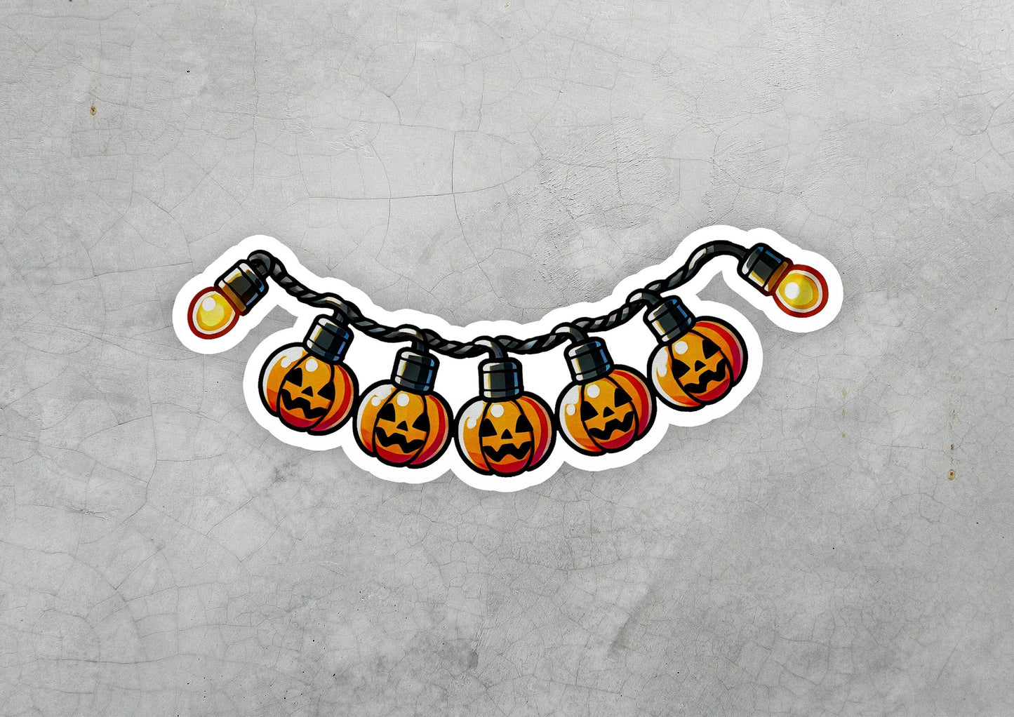 a sticker of a string of halloween lights with jack - o'- lanterns