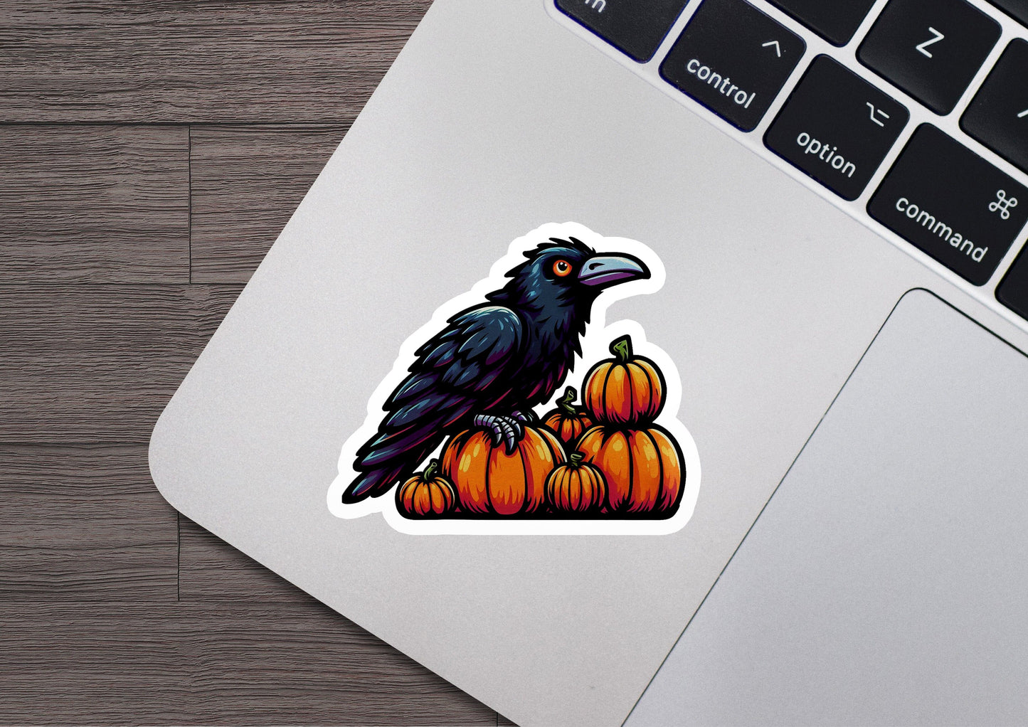 a sticker of a crow sitting on top of pumpkins