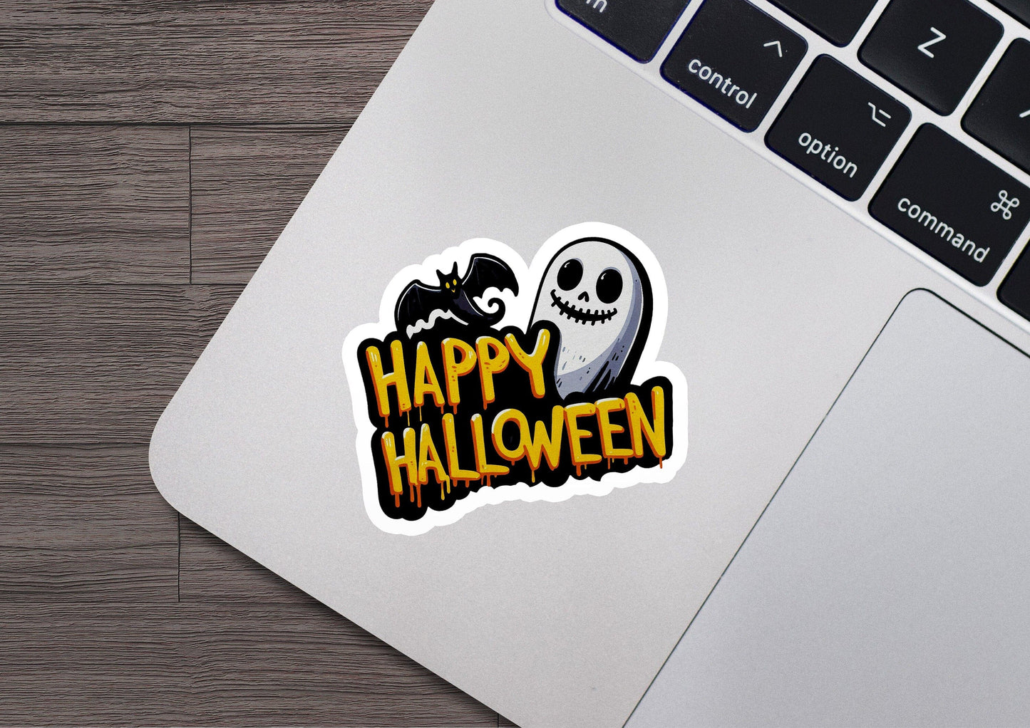 a laptop with a sticker of a skeleton and a ghost