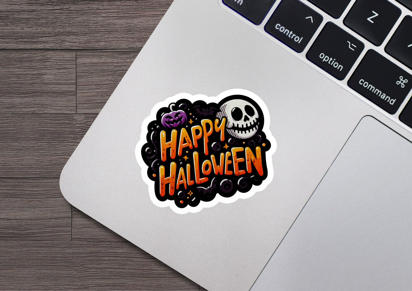 a laptop computer with a sticker of a skull on it