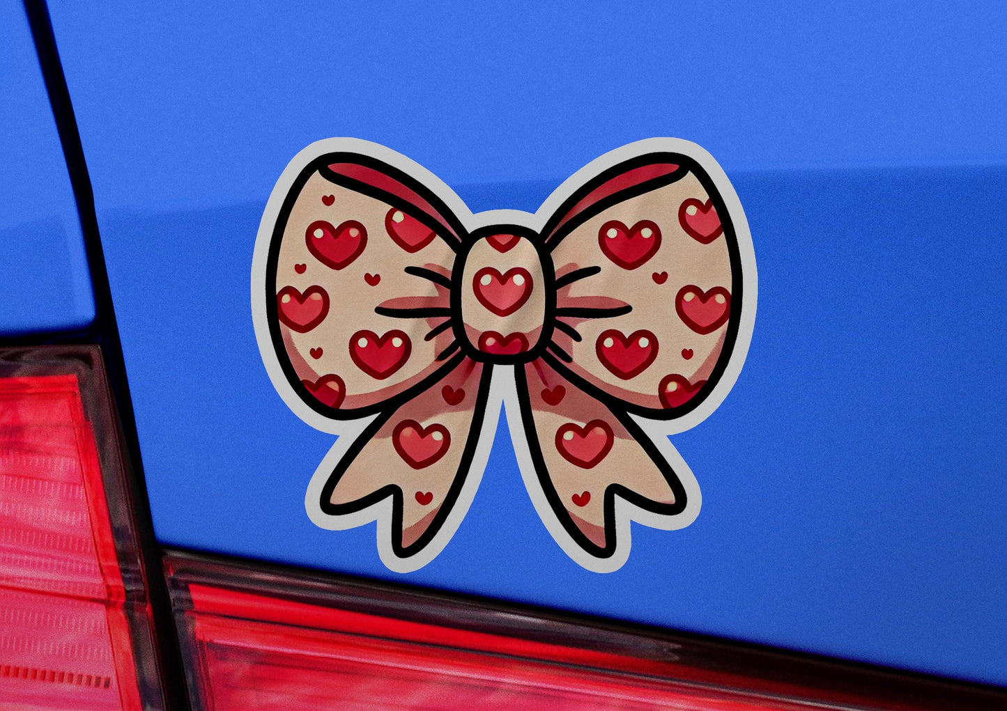 a sticker of a bow with hearts on it
