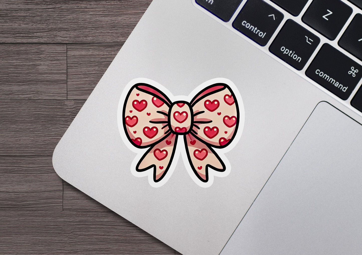 a sticker of a bow with hearts on it