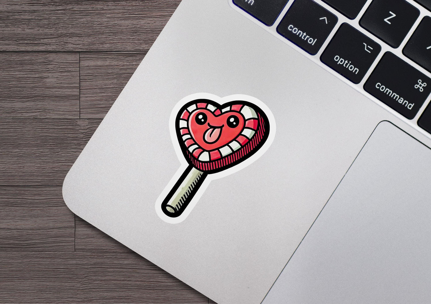 a sticker of a heart shaped lollipop on a laptop