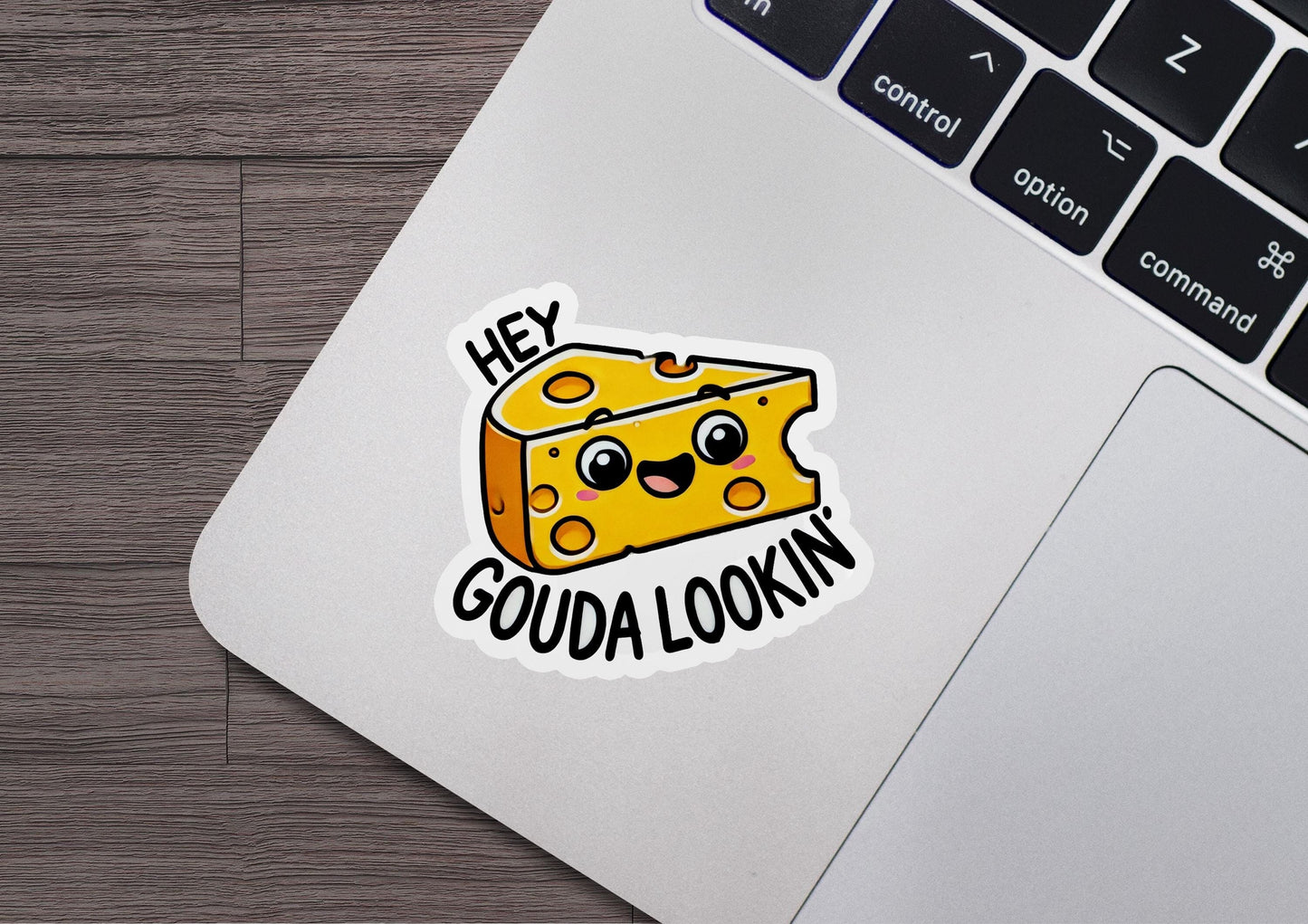 a sticker of a piece of cheese on a laptop