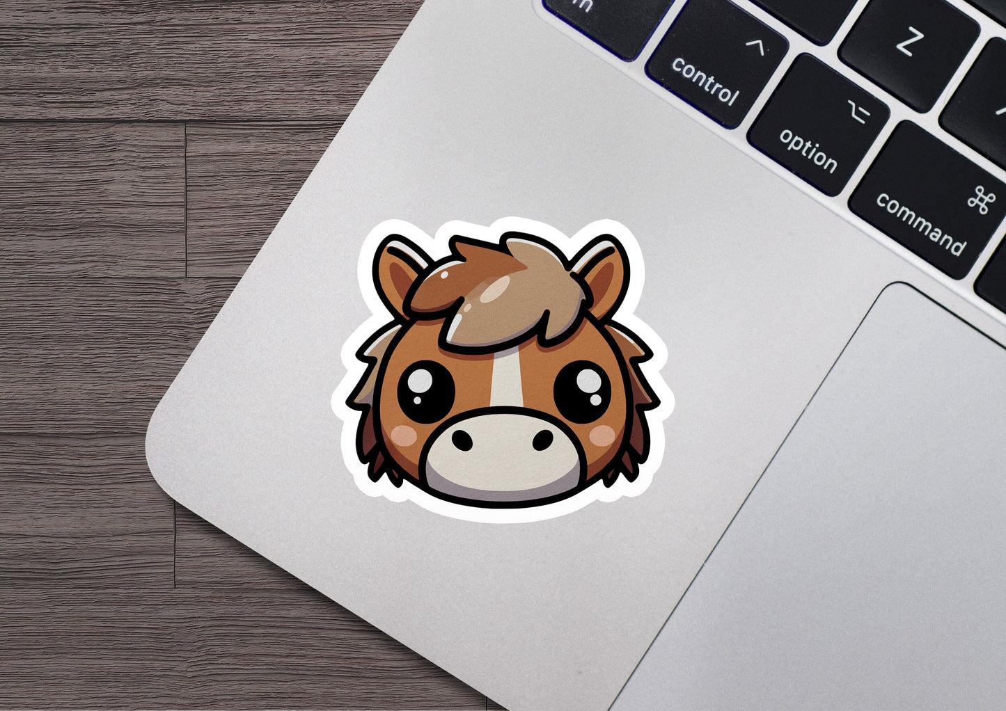 a sticker of a horse's head on a laptop