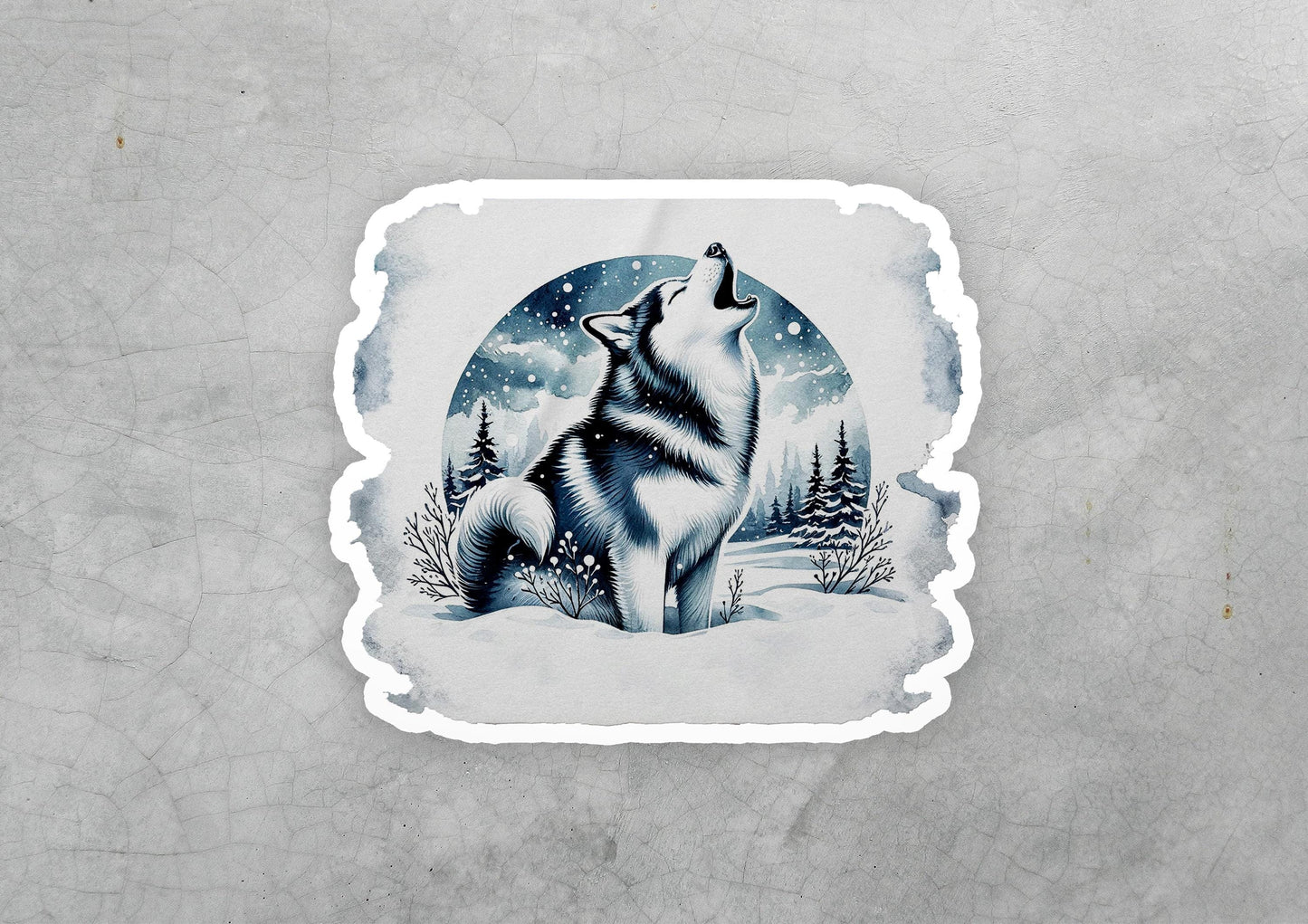 a sticker of a wolf sitting in the snow