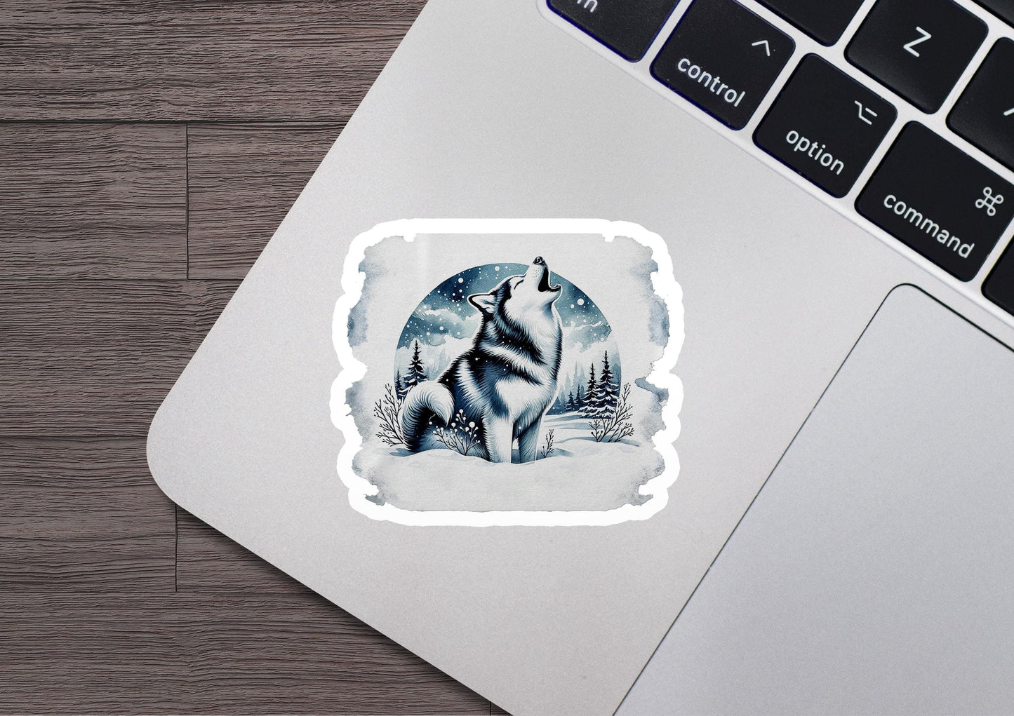 a laptop with a sticker of a wolf on it