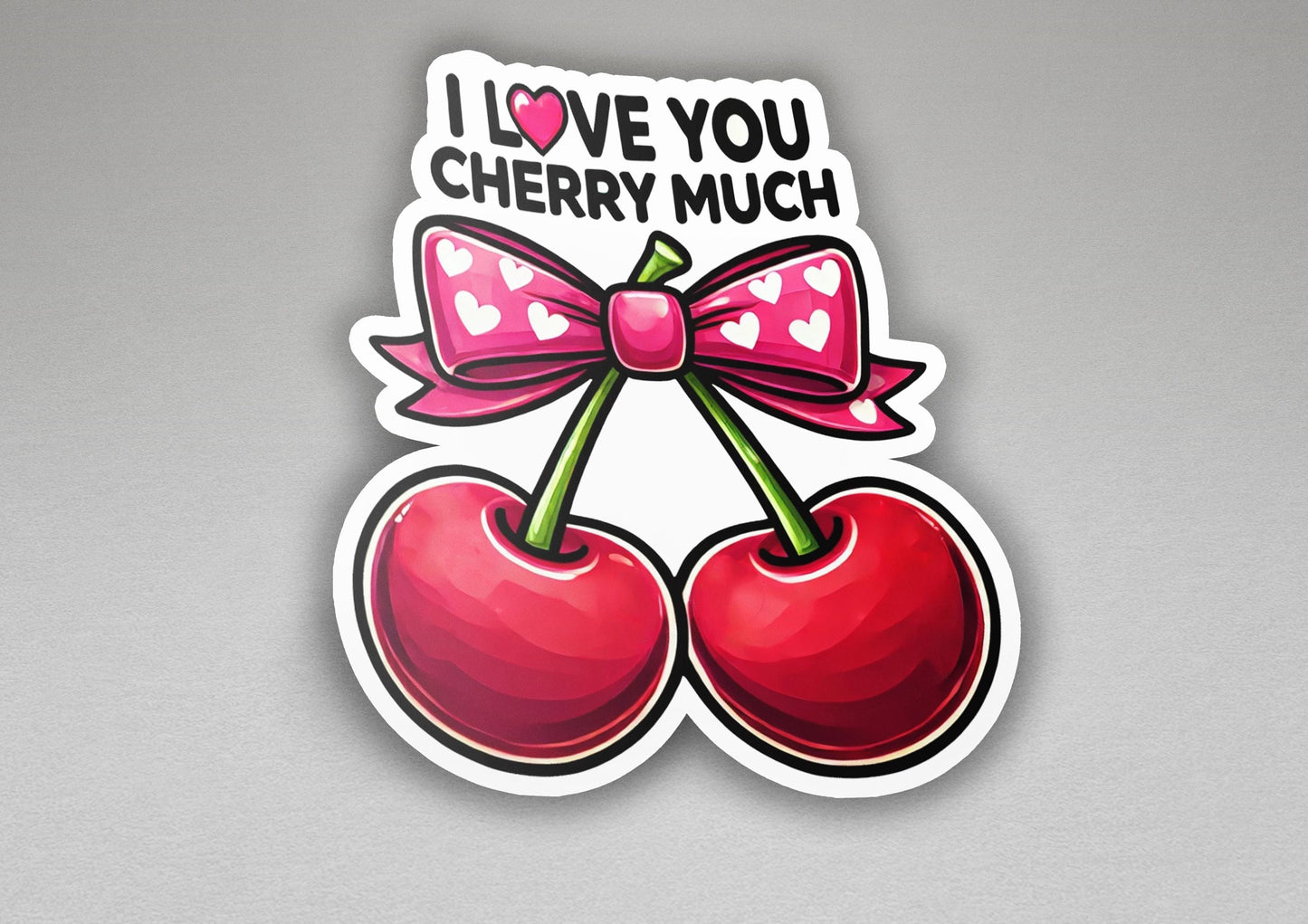 a sticker with a bow and two cherries