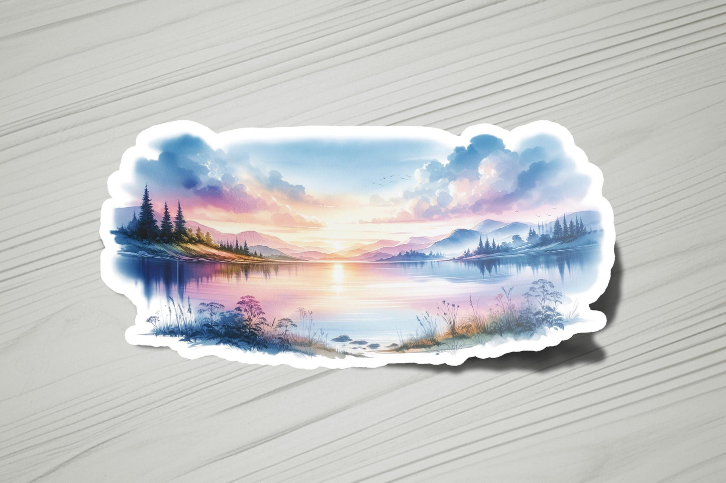 a sticker with a painting of a lake at sunset
