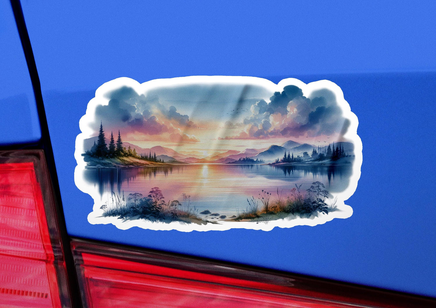 a sticker of a sunset over a lake