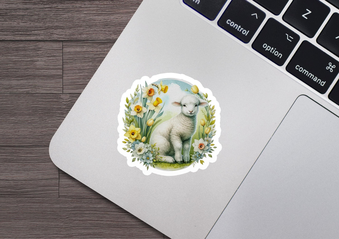 a sticker of a sheep sitting on top of a laptop