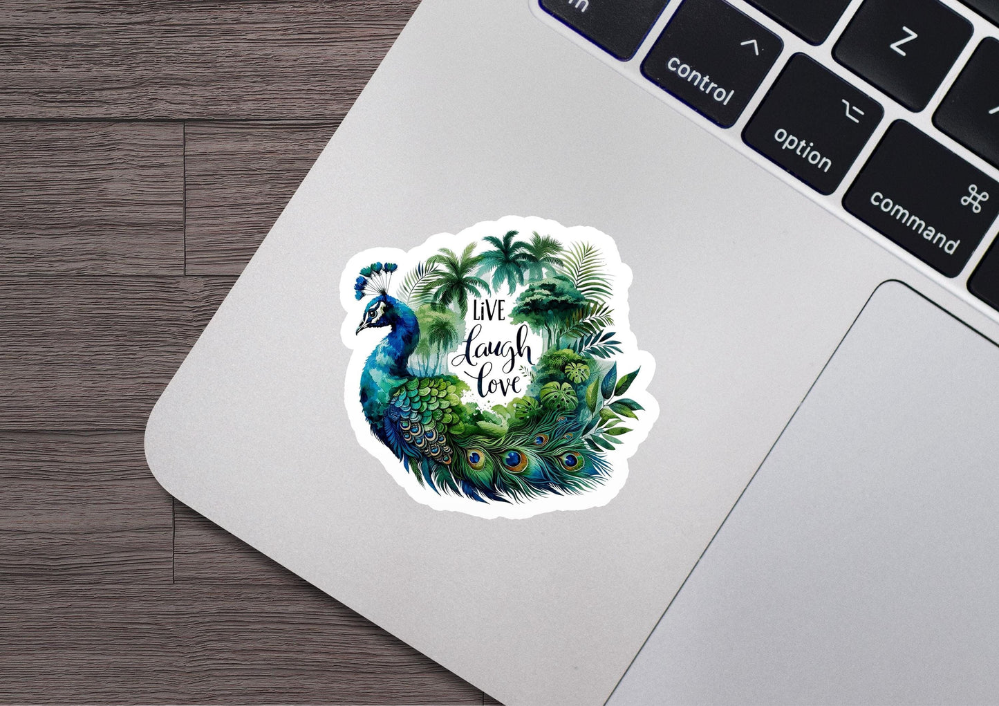 a laptop with a sticker of a peacock and palm trees