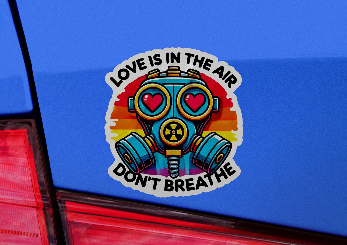 a sticker of a gas mask with the words love is in the air don