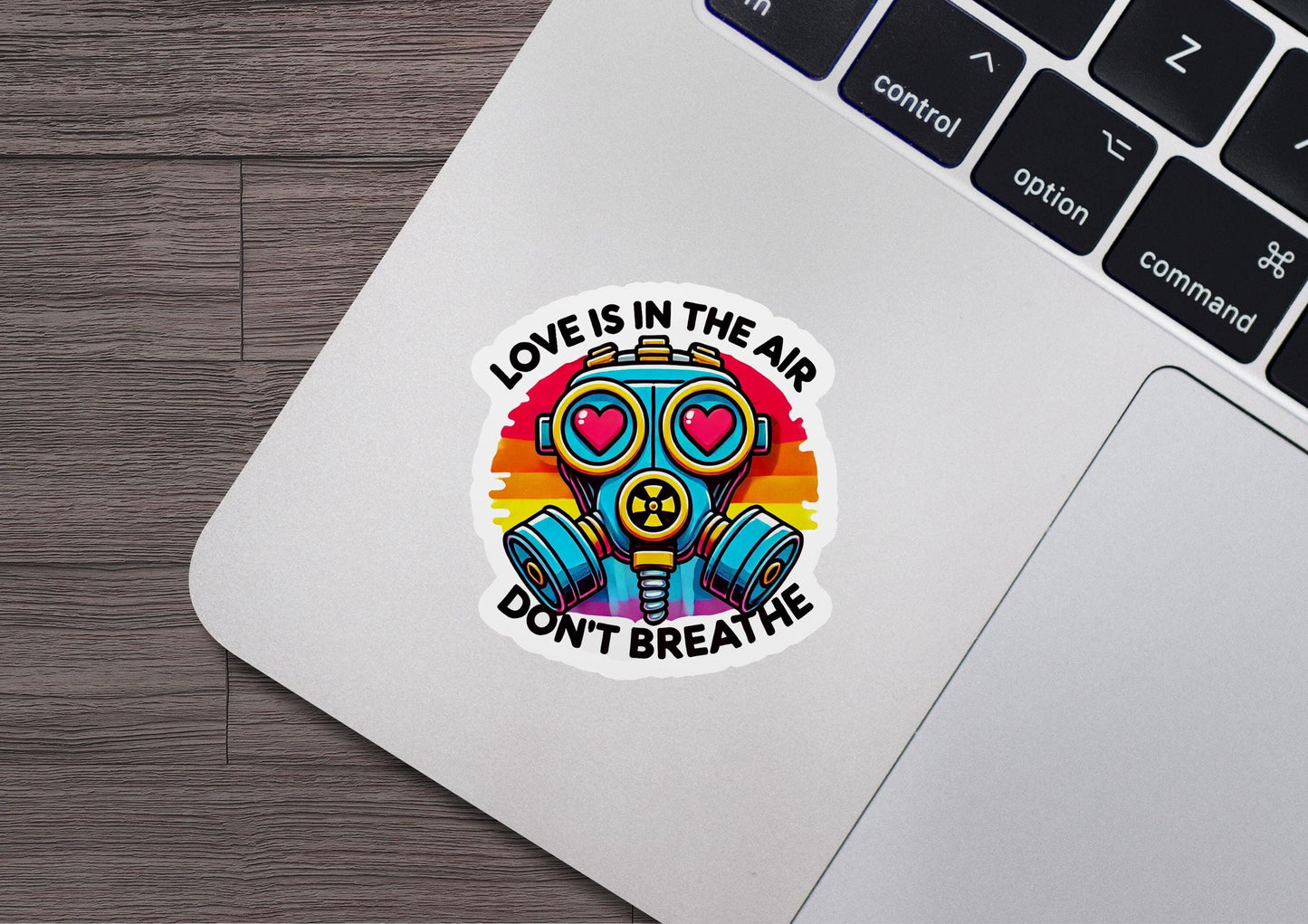 a sticker that says love is in the air don't breathe