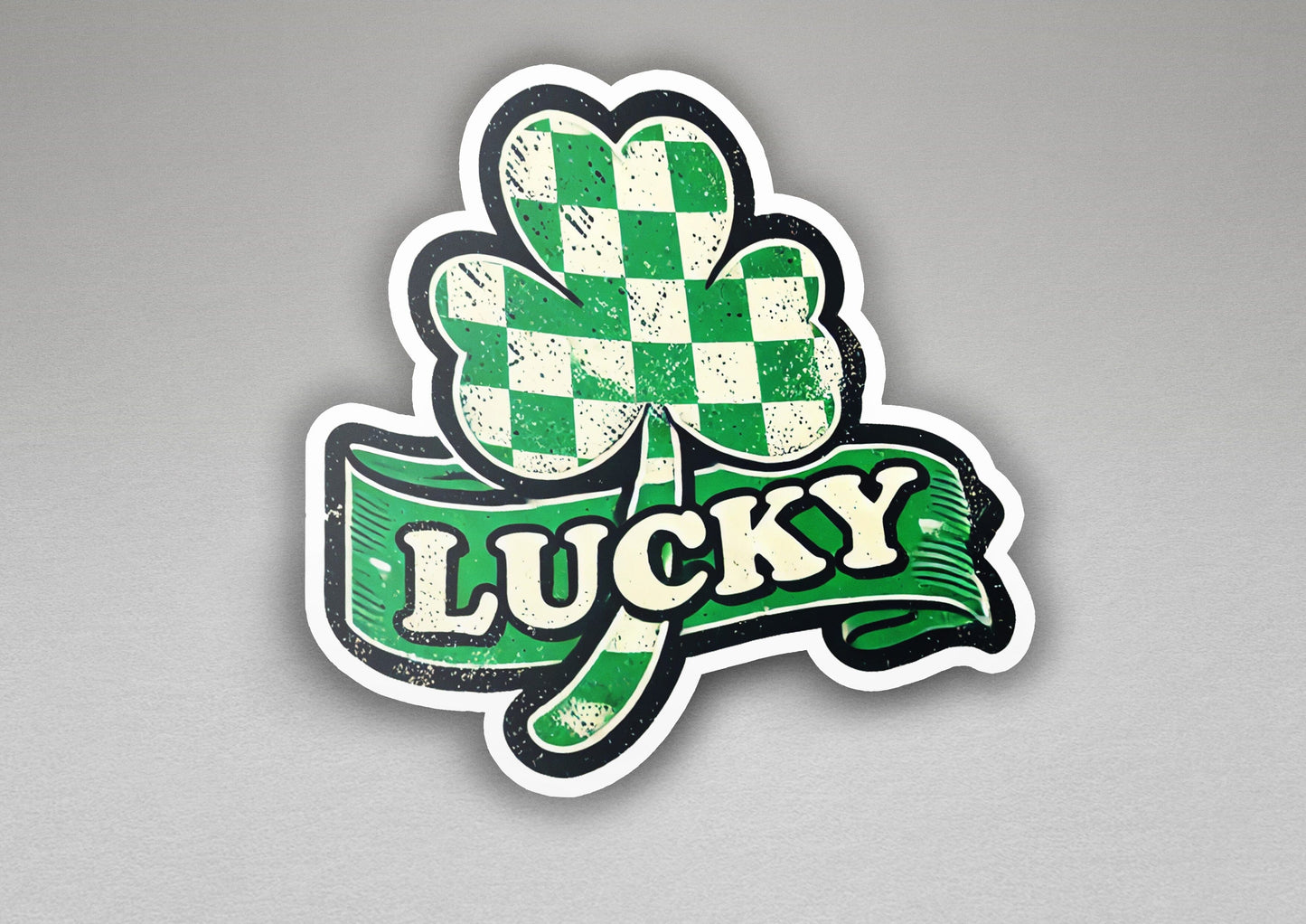 a sticker of a lucky clover with a ribbon