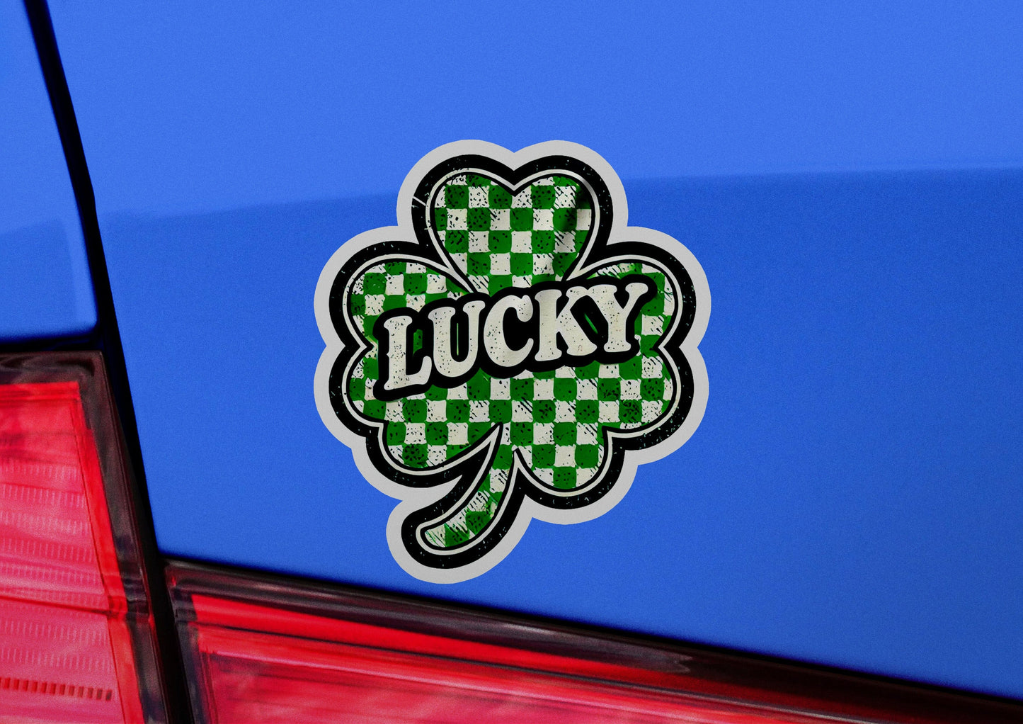 a lucky sticker on the back of a blue car