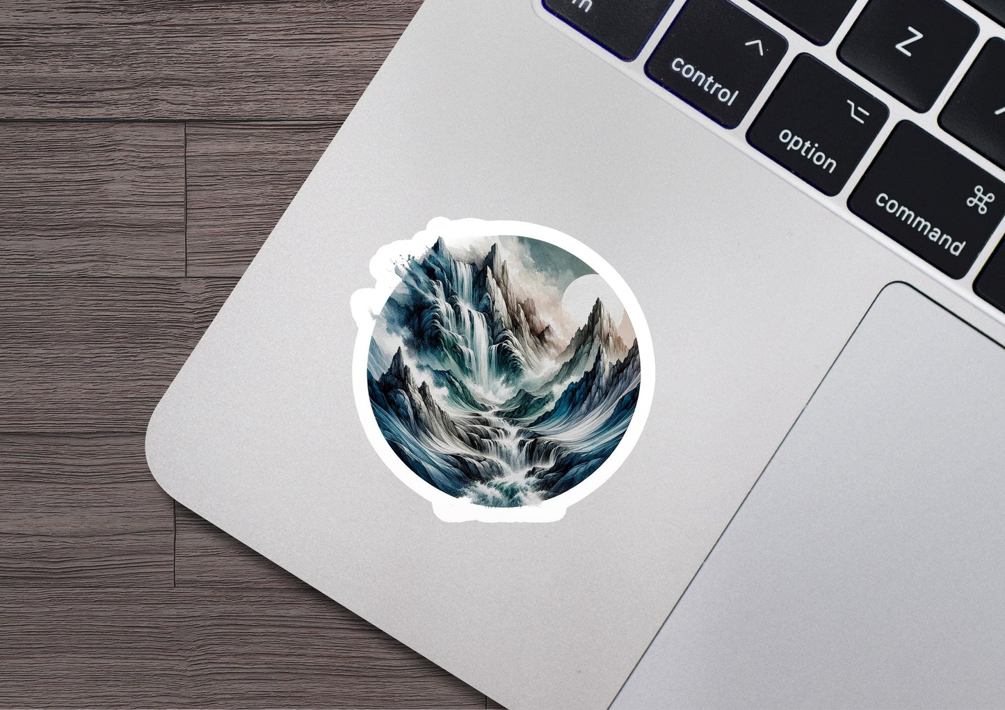 a laptop with a sticker of a mountain scene