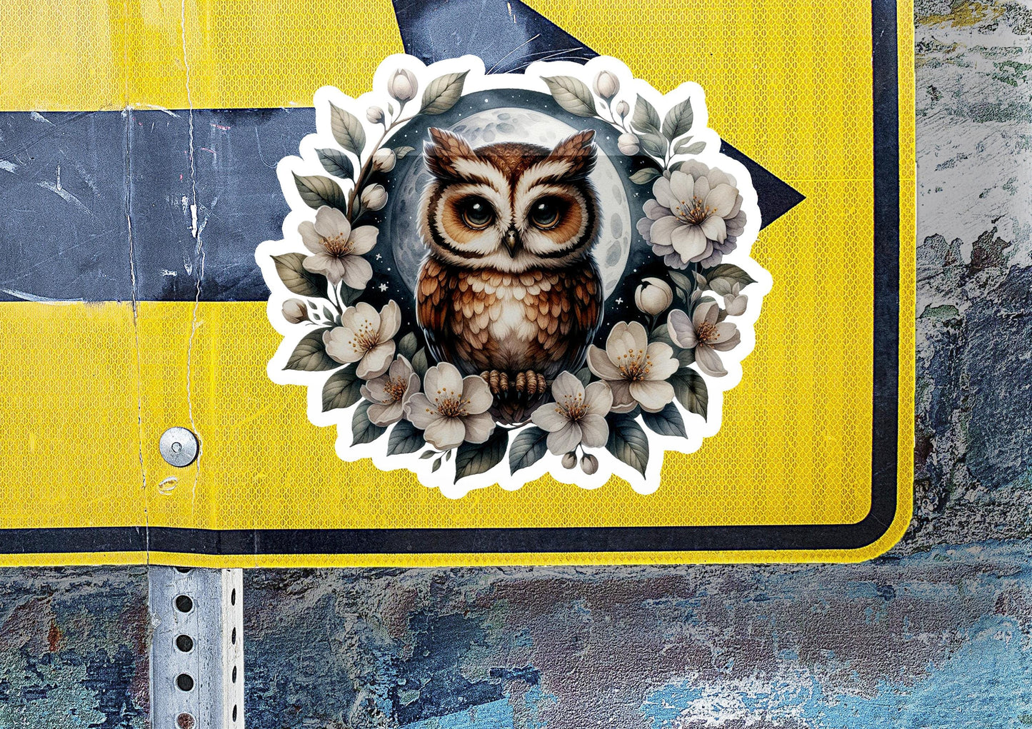 a sticker of an owl on a street sign
