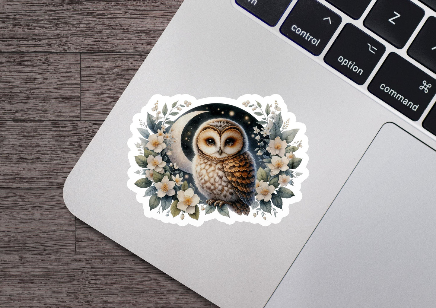 a sticker of an owl sitting on top of a laptop