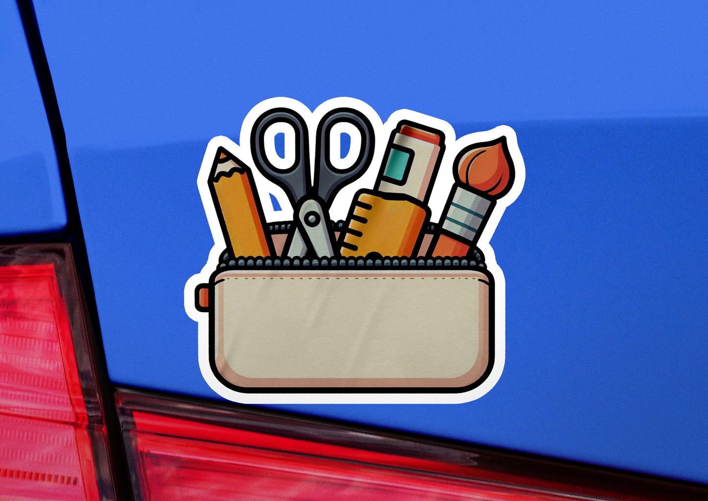 a close up of a car's trunk with scissors and pencils