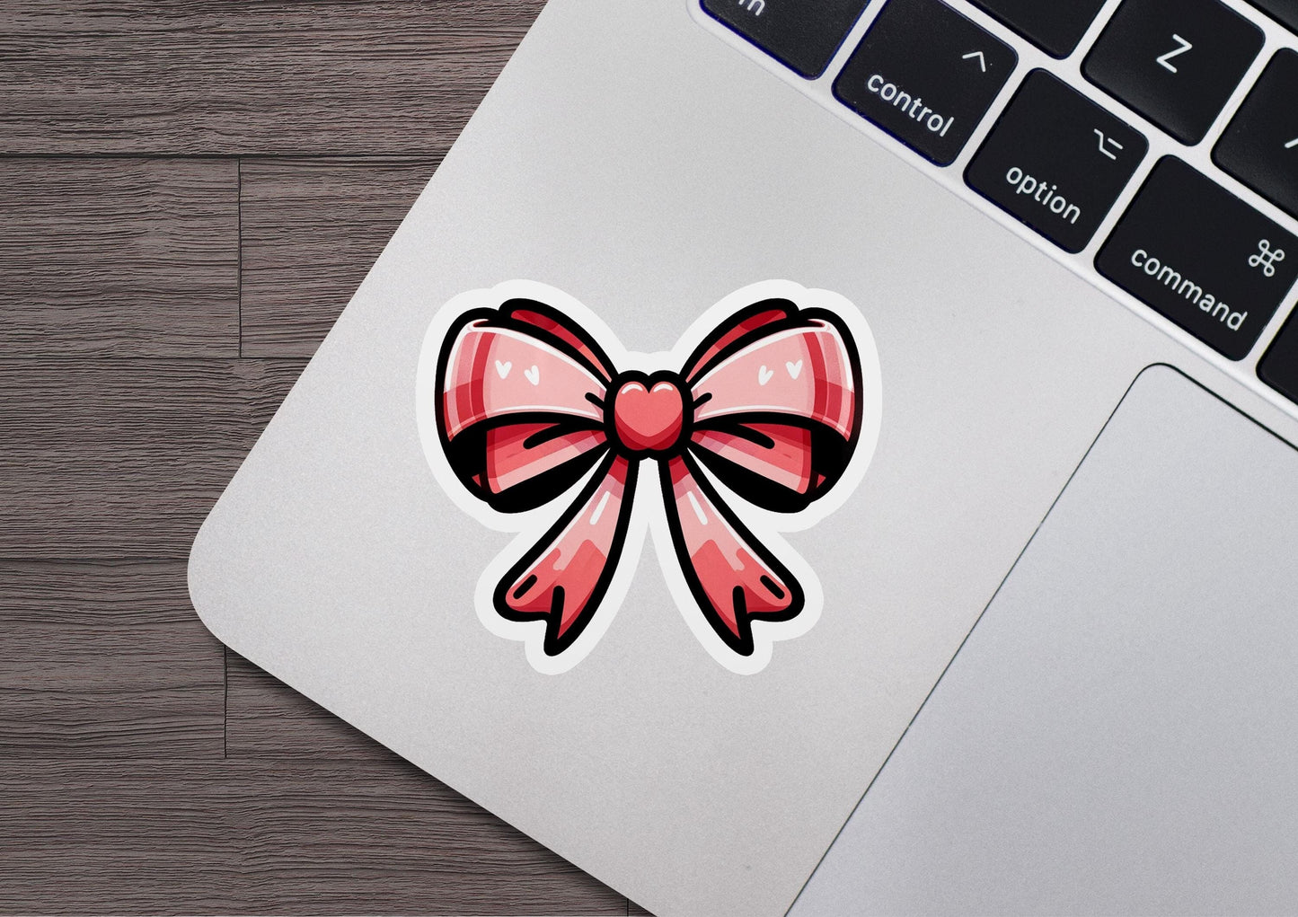 a laptop with a sticker of a bow on it